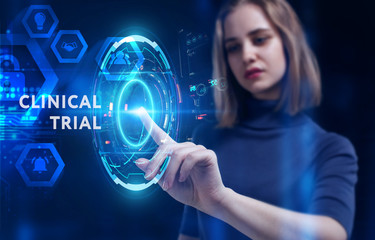 Business, Technology, Internet and network concept. Young businessman working on a virtual screen of the future and sees the inscription: Clinical trial