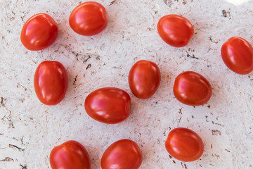 Many red  little tomatoes on the natural background.