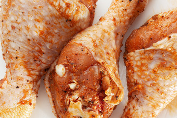 Raw drumsticks on white background. Chicken legs. Raw chicken marinated legs. Top view. Food Background. Cooking content. Uncooked meat. Meat shop concept.
