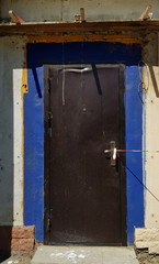 old door in the wall. Grunge textures of building under construction works