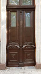 old wooden door. Entrance to ornate brown wood door of historic building in European city Odessa of Ukraine