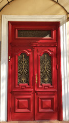 Fototapeta na wymiar old red door. Entrance to ornate red door of historic building in European city Odessa of Ukraine