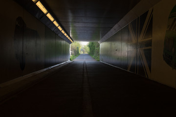 tunnel of light for pedestrians underneath leading to park