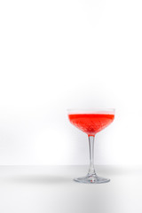 Red cocktail in a glass on a white background