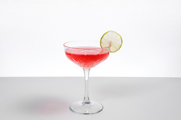 Red cocktail in a glass on a white background