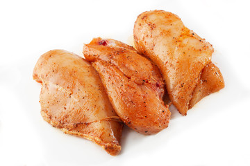 Marinated fillet isolated on a white background. Raw chicken breast fillets. top view with copy space. Flat lay composition with raw chicken breasts. Space for text. Meat shop.
