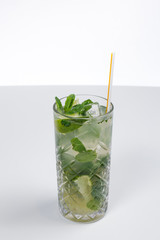 Mojitos cocktail with lime and mint isolated on a white background