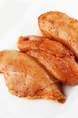 Marinated fillet isolated on a white background. Raw chicken breast fillets. top view with copy space. Flat lay composition with raw chicken breasts. Space for text. Meat shop.