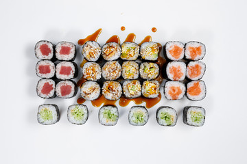 Different kind of rolls and sushi isolated over white background. top view.