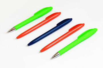 multi-colored stationery pens for writing on a white background