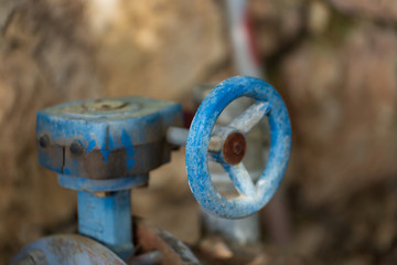 selective focus of Round rusty valve on a pipe in the street