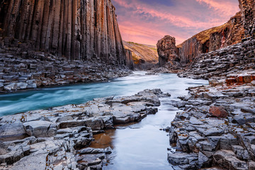 Impressively beautiful nature of Iceland. Fantastic evening landscape. Studlagil canyon of dramatic light during sunset. popular location for landscape photographers and bloggers.