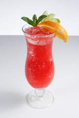 Red cocktail in a glass on a white background