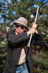 Elderly man threatening with a cane