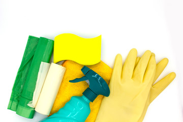 Cleaning products like a sponge, dishwasher tablet, gloves, spray bottle, garbage bag and a rag on white background with copyspace close up top view. concept clean house and hand care