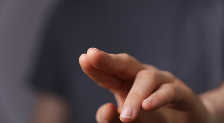 Obraz premium A man hand touching virtual screen, modern background concept , can put your text at the finger, copy space.