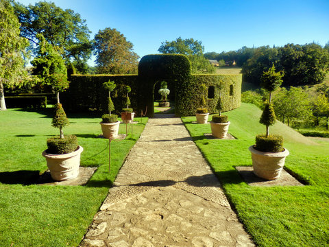 Box topiary circular room with cut out windows found in Eyrignac Manor Garden, Dordogne, France