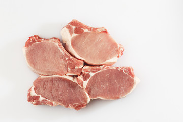 slices pork loin on a white background. Raw pork. Advertising for meat shop and farm. Various kinds of meat and ready to cook concept. Top view. Space for text