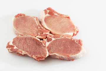 slices pork loin on a white background. Raw pork. Advertising for meat shop and farm. Various kinds of meat and ready to cook concept. Top view. Space for text