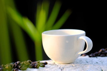 Coffee cup and coffee beans on wooden table background