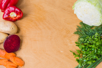 The layout of spring vegetables on a cutting board from above. Background layout with free text space.