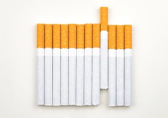 Long row of cigarettes with orange filter tips