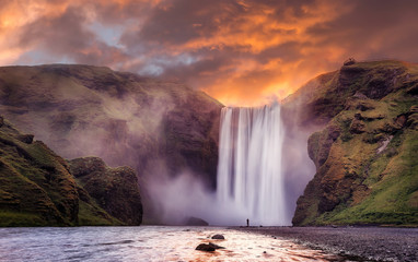 The Incredible landscape of Skogafoss waterfall  in North-Iceland with colorful sky during sunset....