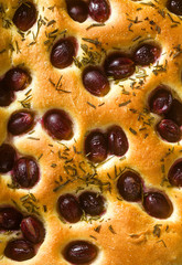 focaccia with red grapes on a blue table. Italian Cuisine, the perfect appetizer