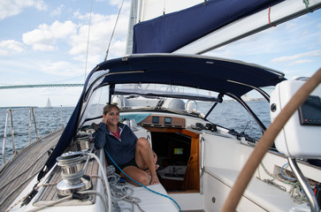 Young woman on a sailboat 