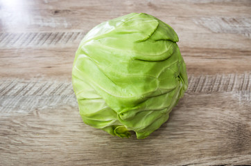 young cabbage on a wooden background.