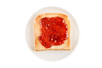 Fried toast spread with raspberry jam on a saucer isolated on a white background.