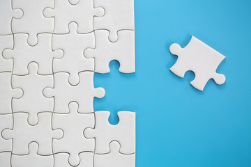 Jigsaw puzzle with missing piece. Completing final task, missing jigsaw puzzle pieces and business...