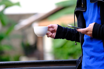 holding a cup of coffee and space for text