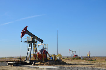 Oil drilling derricks at desert oilfield for fossil fuels output and crude oil production from the...