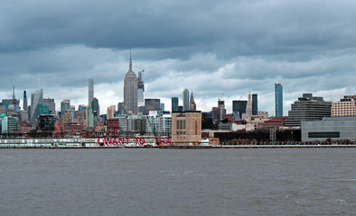 Obraz premium New york, USA - 20.12.2019: New York, Manhattan skyscrapers skyline behind across Hudson river at end of day New York, USA - stock photo