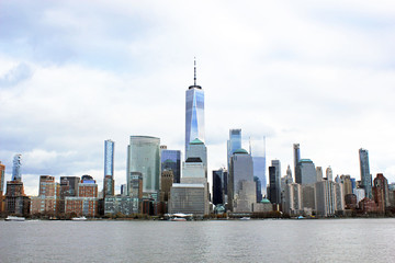 Obraz premium New York, USA - 20/12/2019: One world trade centre Building, observation tower Manhattan New York skyline skyscraper from ferry approaching downtown city. stock photo
