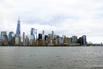 Obraz premium New York, USA - 20/12/2019: One world trade centre Building, observation tower Manhattan New York skyline skyscraper from ferry approaching downtown city. stock photo