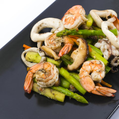 Stir fried asparagus with squid and shrimp with oyster sauce.