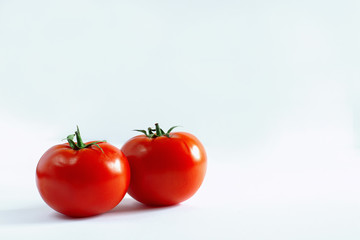two red tomato on a white background
