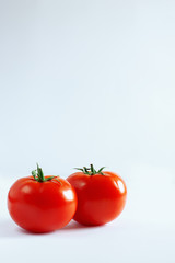 two red tomato on a white background
