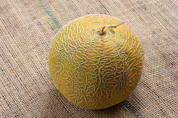 sweet, yellow melon on burlap