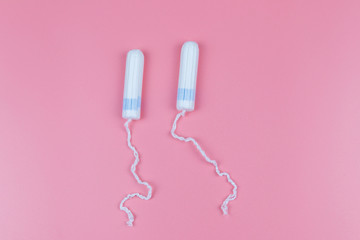 Tampons on a pastel pink background. Top view