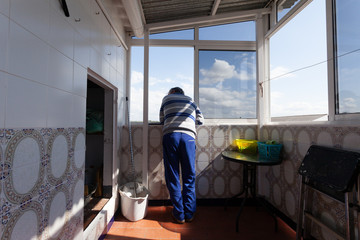 Man leaning out the window of his house