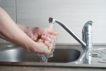 Caucasian woman hands under stream of water. Hand washing concept