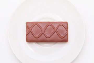 Chocolate biscuit in a white plate isolated on a white background