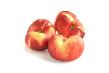 Three flat fig peaches isolated on white