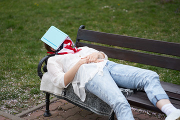 Caucasian girl sleeping on bench in park with protecting american flag bandage on face during outbreak