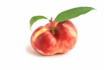 Flat fig peach with leaves isolated on white
