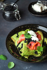 spinach crepes with salmon, cream cheese and caviar