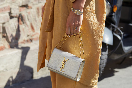 Woman With Golden Dress, Silver Yves Saint Laurent Bag And Rolex Watch On September 21, 2019 In Milan, Italy